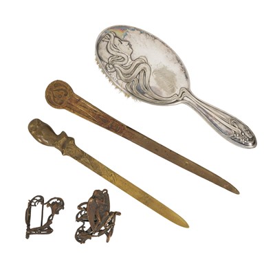 Lot 420 - Art Nouveau, a buckle, hairbrush and two letter knives, late 19th century