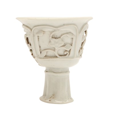 Lot 256 - A Chinese qingbai moulded 'prunus' stem cup, Yuan dynasty