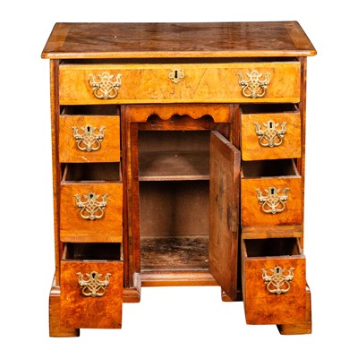 Lot 32 - A George II and later figured and burr walnut kneehole desk
