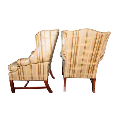 Lot 59 - A pair of George III style wingback armchairs