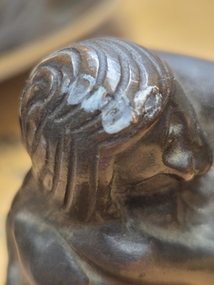 Lot 75 - A patinated bronze model of a crouching female nude