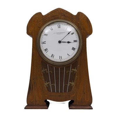 Lot 51 - An Art Nouveau inlaid mahogany mahogany mantel clock with white enamel dial