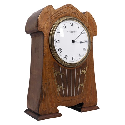Lot 51 - An Art Nouveau inlaid mahogany mahogany mantel clock with white enamel dial