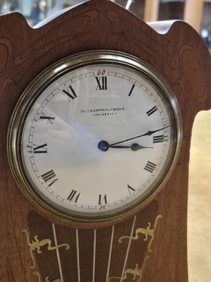 Lot 51 - An Art Nouveau inlaid mahogany mahogany mantel clock with white enamel dial