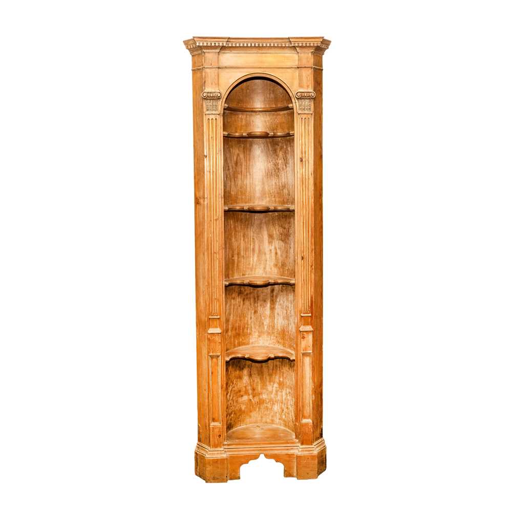 Lot 28 - A Neoclassical style limed pine corner niche bookcase of architectural form, 19th century