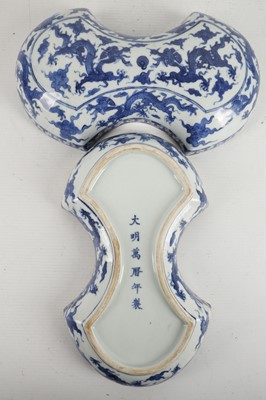 Lot 541 - A Chinese blue and white 'dragons' cash-shaped...