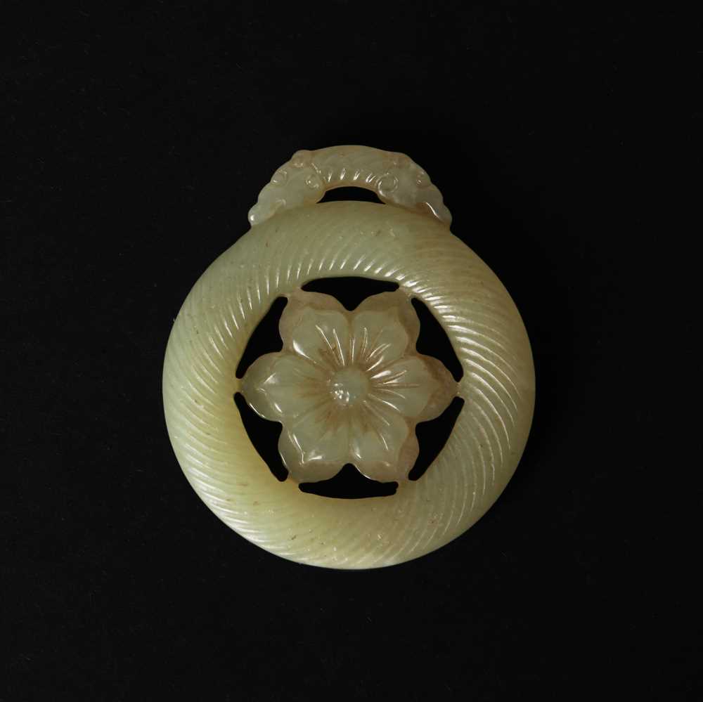 Lot 510 - A Chinese jade 'flower' pendant, 19th - 20th century