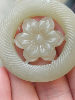 Lot 510 - A Chinese jade 'flower' pendant, 19th - 20th century