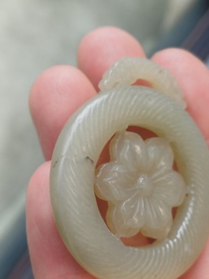 Lot 510 - A Chinese jade 'flower' pendant, 19th - 20th century