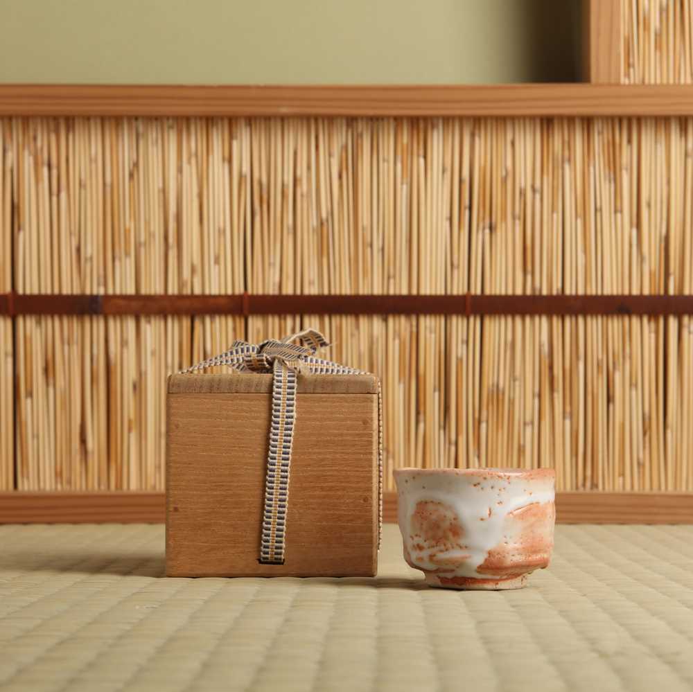 Lot 30 - A Japanese Shino ware sake cup (guinomi), 20th - 21st century