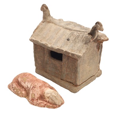Lot 682 - A Chinese pottery figure of a prostrating official and a house, Tang/Song dynasty
