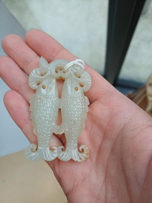 Lot 531 - A Chinese jade 'twin fish' pendant plaque, Qing dynasty