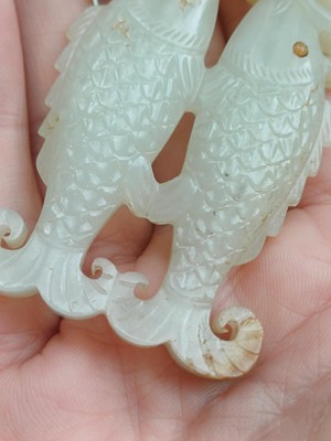 Lot 531 - A Chinese jade 'twin fish' pendant plaque, Qing dynasty