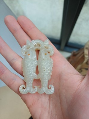 Lot 531 - A Chinese jade 'twin fish' pendant plaque, Qing dynasty