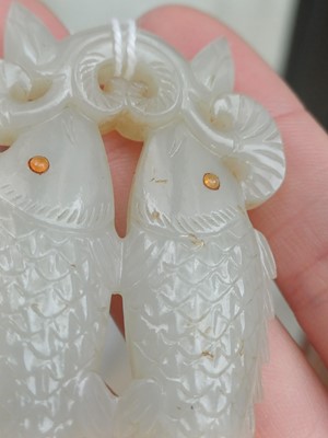 Lot 531 - A Chinese jade 'twin fish' pendant plaque, Qing dynasty