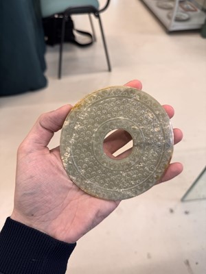 Lot 521 - A Chinese archaistic jade bi disc, 19th/20th century or earlier