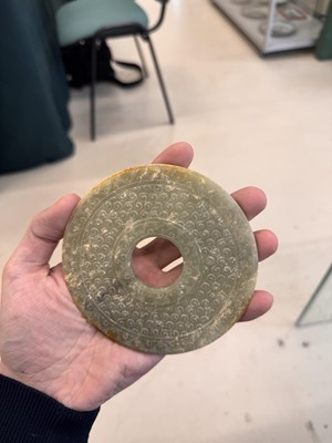 Lot 521 - A Chinese archaistic jade bi disc, 19th/20th century or earlier