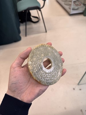 Lot 521 - A Chinese archaistic jade bi disc, 19th/20th century or earlier