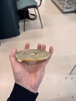 Lot 521 - A Chinese archaistic jade bi disc, 19th/20th century or earlier