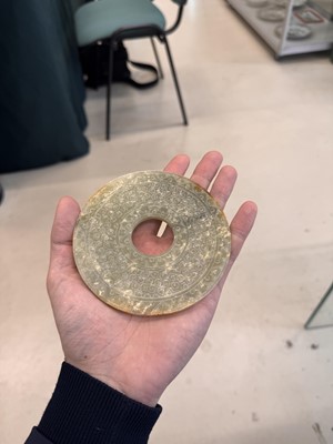 Lot 521 - A Chinese archaistic jade bi disc, 19th/20th century or earlier
