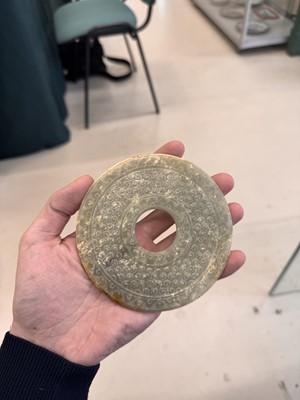 Lot 521 - A Chinese archaistic jade bi disc, 19th/20th century or earlier