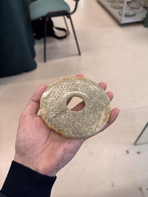 Lot 521 - A Chinese archaistic jade bi disc, 19th/20th century or earlier