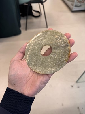 Lot 521 - A Chinese archaistic jade bi disc, 19th/20th century or earlier