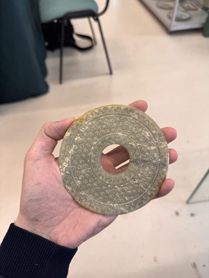 Lot 521 - A Chinese archaistic jade bi disc, 19th/20th century or earlier