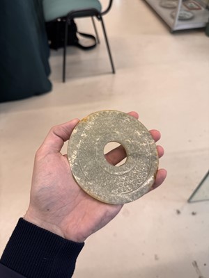 Lot 521 - A Chinese archaistic jade bi disc, 19th/20th century or earlier