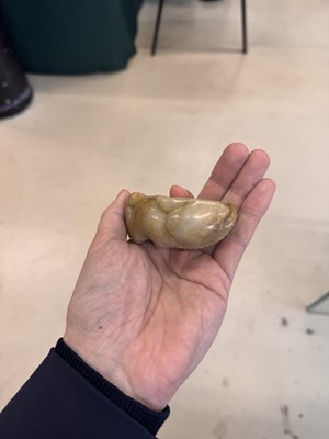 Lot 525 - A Chinese jade 'recumbent camel' figure, Song dynasty or later