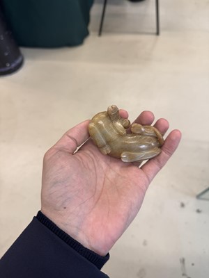 Lot 525 - A Chinese jade 'recumbent camel' figure, Song dynasty or later