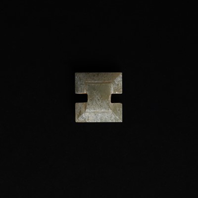 Lot 514 - A Chinese jade archaistic bead, 19th century or earlier