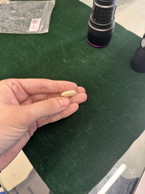 Lot 514 - A Chinese jade archaistic bead, 19th century or earlier