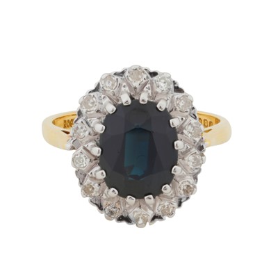 Lot 69 - A sapphire and diamond halo ring, circa 1975