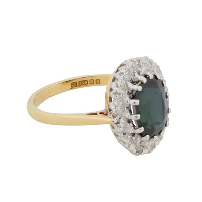 Lot 69 - A sapphire and diamond halo ring, circa 1975