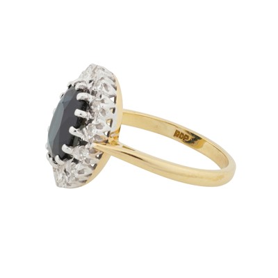 Lot 69 - A sapphire and diamond halo ring, circa 1975