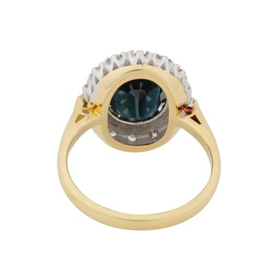 Lot 69 - A sapphire and diamond halo ring, circa 1975