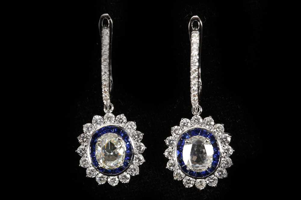 Lot 548 - A pair o 18ct white gold, sapphire and diamond...