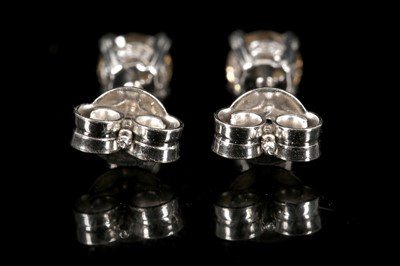 Lot 555 - A pair of 18ct white gold, champagne diamond...