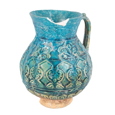 Lot 148 - A Bamiyan moulded and turquoise-glazed pottery jug (damaged)