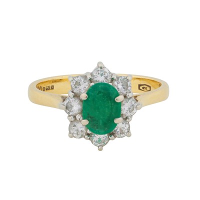 Lot 241 - An emerald and diamond halo ring