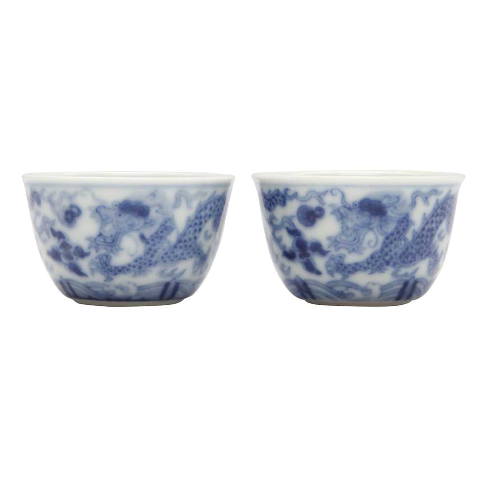 Lot 68 - Two Chinese blue and white 'dragon' cups, Qing dynasty, Guangxu period