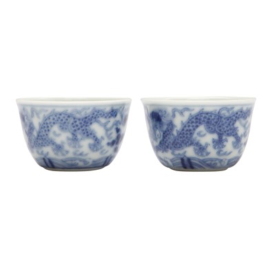 Lot 68 - Two Chinese blue and white 'dragon' cups, Qing dynasty, Guangxu period