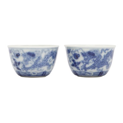 Lot 68 - Two Chinese blue and white 'dragon' cups, Qing dynasty, Guangxu period