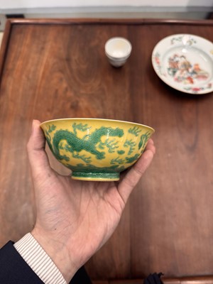 Lot 59 - A Chinese yellow-ground green-enamelled 'dragon' bowl, Qing dynasty, Tongzhi mark and of the period