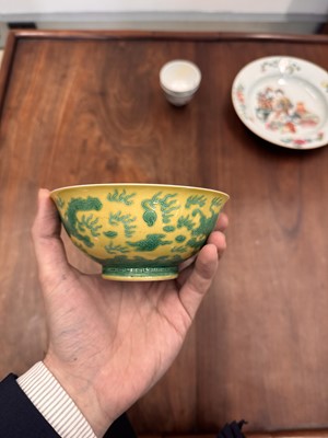 Lot 59 - A Chinese yellow-ground green-enamelled 'dragon' bowl, Qing dynasty, Tongzhi mark and of the period