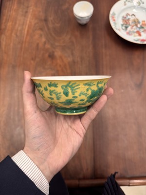 Lot 59 - A Chinese yellow-ground green-enamelled 'dragon' bowl, Qing dynasty, Tongzhi mark and of the period