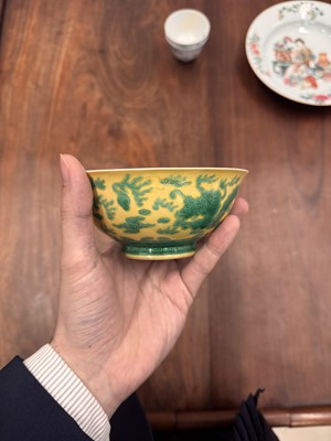 Lot 59 - A Chinese yellow-ground green-enamelled 'dragon' bowl, Qing dynasty, Tongzhi mark and of the period