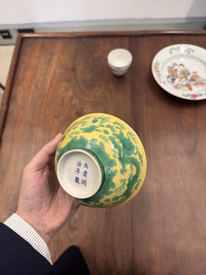 Lot 59 - A Chinese yellow-ground green-enamelled 'dragon' bowl, Qing dynasty, Tongzhi mark and of the period