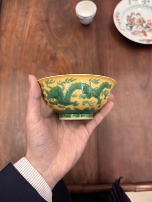 Lot 59 - A Chinese yellow-ground green-enamelled 'dragon' bowl, Qing dynasty, Tongzhi mark and of the period